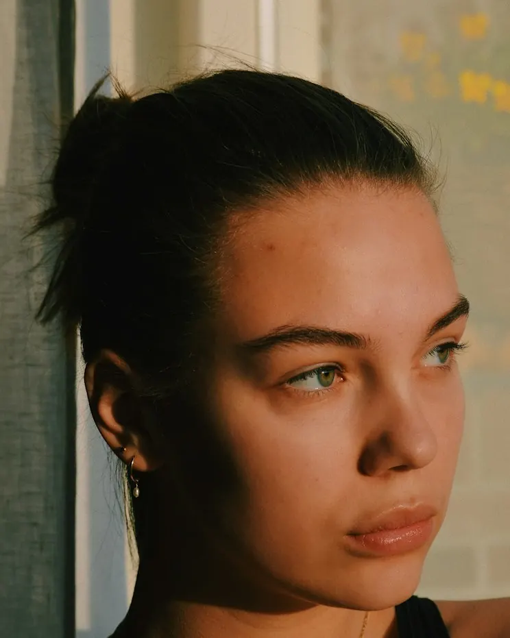 Portrait of a person with ear and facial piercings